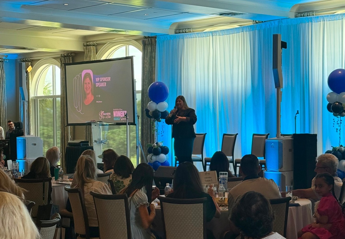 Orly Amor delivering a VIP sponsor keynote at a women's summit